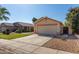 Well-maintained home with a two-car garage, desert landscaping, and a cozy front yard at 15558 N 136Th Ln, Surprise, AZ 85374