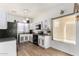 Well-lit kitchen with white and grey cabinets, modern appliances, and wood-look floors, offering a functional cooking space at 15558 N 136Th Ln, Surprise, AZ 85374