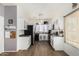 Well-lit kitchen with white cabinets, modern appliances, and wood-look floors, offering a functional cooking space at 15558 N 136Th Ln, Surprise, AZ 85374