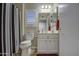 Neat bathroom featuring a vanity, mirror, and striped shower curtain at 16118 W Vista North Dr, Sun City West, AZ 85375