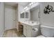 Well-lit bathroom featuring a vanity with white cabinets and a wall-mounted mirror with decorative lighting at 16118 W Vista North Dr, Sun City West, AZ 85375