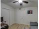 Bedroom with a ceiling fan, closet, and a cozy gray sofa providing a versatile living space at 16118 W Vista North Dr, Sun City West, AZ 85375