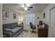 Inviting bedroom featuring a comfortable gray sofa, modern ceiling fan, and bright natural light at 16118 W Vista North Dr, Sun City West, AZ 85375