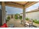 Relaxing covered patio area with outdoor seating, showcasing views of the well-manicured backyard and landscaping at 16118 W Vista North Dr, Sun City West, AZ 85375