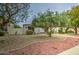 Well-kept home featuring neat landscaping, a mature tree, and a walkway leading to the welcoming front entrance at 16118 W Vista North Dr, Sun City West, AZ 85375