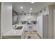 Bright white kitchen features stainless steel appliances, wood floors, and modern countertops at 16118 W Vista North Dr, Sun City West, AZ 85375