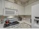 Close-up of the kitchen featuring white appliances and cabinets with ample counter space at 16118 W Vista North Dr, Sun City West, AZ 85375