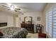 Spacious bedroom featuring a ceiling fan, dresser, and decorative bed, providing a comfortable retreat at 16118 W Vista North Dr, Sun City West, AZ 85375