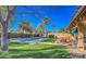 Lush backyard showcasing a refreshing pool, relaxing hot tub, covered patio, and mature trees for a private oasis at 16402 N 48Th Way, Scottsdale, AZ 85254