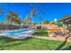 Private backyard featuring a pool, hot tub, well-maintained lawn, mature landscaping, and a covered patio for entertaining at 16402 N 48Th Way, Scottsdale, AZ 85254