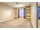 Neutral-toned bedroom featuring built-in shelving units and a large mirror with carpeted flooring at 16402 N 48Th Way, Scottsdale, AZ 85254