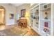 Entryway with a piano, rug, and built-in shelves displays a well-lit and inviting space at 16402 N 48Th Way, Scottsdale, AZ 85254