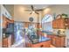 Modern kitchen with wood cabinets, black granite countertops, stainless steel appliances, and a large island at 16402 N 48Th Way, Scottsdale, AZ 85254