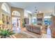 Expansive living room with high ceilings, a stone fireplace, and seamless flow to other living spaces at 16402 N 48Th Way, Scottsdale, AZ 85254