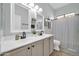 The bathroom boasts a dual vanity sink with black fixtures and modern lighting at 16813 W Hammond St, Goodyear, AZ 85338