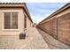 Gravel side yard features an enclosed space, walkway and well-maintained exterior at 16813 W Hammond St, Goodyear, AZ 85338