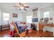 Cozy bedroom featuring hardwood floors and a ceiling fan at 1722 N 77Th Gln, Phoenix, AZ 85035