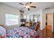 Cozy bedroom featuring hardwood floors and a ceiling fan at 1722 N 77Th Gln, Phoenix, AZ 85035