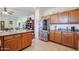 Galley kitchen with oak cabinets and stainless refrigerator with view into living spaces at 1722 N 77Th Gln, Phoenix, AZ 85035