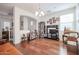 Spacious living room featuring hardwood floors, built-in shelving, entertainment center and lots of light at 1722 N 77Th Gln, Phoenix, AZ 85035