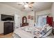 Well lit bedroom with a bed, large dresser and a view of the bathroom and private backyard at 1722 N 77Th Gln, Phoenix, AZ 85035