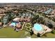 Expansive aerial view of the community, highlighting the pool, lagoon, clubhouse, and tennis courts at 1737 E Marquette Dr, Gilbert, AZ 85234