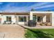 Backyard featuring an outdoor seating area and lush green lawn at 1737 E Marquette Dr, Gilbert, AZ 85234