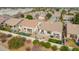 An aerial view of a backyard with a patio, pool, fire pit, and green lawn surrounded by neighboring houses at 1737 E Marquette Dr, Gilbert, AZ 85234