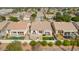 An aerial view of a backyard with a patio, pool, fire pit, and green lawn surrounded by neighboring houses at 1737 E Marquette Dr, Gilbert, AZ 85234