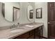 Bathroom featuring double sinks with granite countertop and decorative mirrors at 1737 E Marquette Dr, Gilbert, AZ 85234