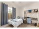 Inviting bedroom featuring natural light, a built-in desk, and carpeted floors at 1737 E Marquette Dr, Gilbert, AZ 85234