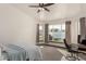 Bright bedroom features neutral carpet, a large window for natural light, and a ceiling fan at 1737 E Marquette Dr, Gilbert, AZ 85234