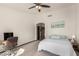 Bedroom featuring a calming color scheme, neutral carpet, and a ceiling fan at 1737 E Marquette Dr, Gilbert, AZ 85234