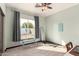 Bright bedroom with neutral carpet, a large window for natural light, and a ceiling fan at 1737 E Marquette Dr, Gilbert, AZ 85234