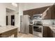 Modern kitchen with stainless steel appliances, mosaic tile backsplash, and ample cabinet space at 1737 E Marquette Dr, Gilbert, AZ 85234