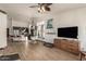 Open-concept living room featuring modern decor, wood-look tile flooring, and a spacious kitchen view at 1737 E Marquette Dr, Gilbert, AZ 85234