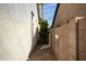 Side yard with pavers, white stucco wall and minimal foliage at 1737 E Marquette Dr, Gilbert, AZ 85234