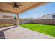 Backyard with a covered patio, green grass, and a flower bed, perfect for outdoor enjoyment at 1777 E Dubois Ave, Gilbert, AZ 85298