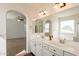 Bright bathroom with double sinks and arched entry to bedroom and bathroom at 1777 E Dubois Ave, Gilbert, AZ 85298