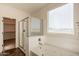 Bathroom showcasing a large bathtub, glass enclosed shower, and natural light at 1777 E Dubois Ave, Gilbert, AZ 85298