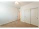 Neutral bedroom features a ceiling fan, closet with sliding doors, and access to the rest of the home at 1777 E Dubois Ave, Gilbert, AZ 85298