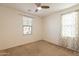 Neutral bedroom with a ceiling fan, a window offering natural light, and comfortable carpeting at 1777 E Dubois Ave, Gilbert, AZ 85298