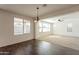 Cozy dining area adjacent to living room with hardwood floors, chandelier and ample natural light at 1777 E Dubois Ave, Gilbert, AZ 85298