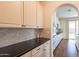 Close-up of kitchen with custom white cabinets, dark granite countertops, and stainless steel appliances at 1777 E Dubois Ave, Gilbert, AZ 85298