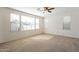 Spacious living room with large windows providing ample natural light and ceiling fan at 1777 E Dubois Ave, Gilbert, AZ 85298