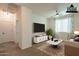 A neutral-toned living room features a ceiling fan, a white sofa, and a view into the hallway at 1777 E Dubois Ave, Gilbert, AZ 85298