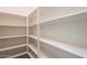 Walk-in pantry with plenty of shelving for organized storage and easy access to kitchen supplies at 1777 E Dubois Ave, Gilbert, AZ 85298