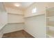 Spacious walk-in closet with ample shelving and hanging space for storage at 1777 E Dubois Ave, Gilbert, AZ 85298