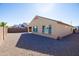 Back exterior featuring gravel, a block fence, and stucco exterior at 19202 W Jackson St, Buckeye, AZ 85326