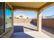 Back patio view showcases a low-maintenance backyard enclosed by a brick wall at 19202 W Jackson St, Buckeye, AZ 85326